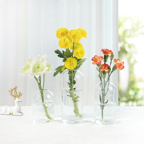 PRICES MAY VARY. VERSATILE DISPLAY: These small glass bud vases offer a simple way to showcase small floral arrangements on tables, desks, shelves and more around your home or event. ELEGANT AMBIANCE: The transparent glass construction allows the natural beauty of your floral selection to shine through, adding lovely decorative accents to living areas, dining spaces and beyond. MULTIPLE USES: Whether you need single stem vases for a minimalist look or grouped ensembles for full floral displays, Floating Flower Candles, Vase For Living Room, Dining Table Wedding, Home Decor Floral Arrangements, Glass Bud Vases, Vases For Flowers, Living Room Dining Table, Vase Transparent, Small Glass Vases