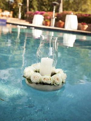 Floating Florals    If your venue has a pool, floating decor is a must. Pillar candles surrounded by all-white flowers have a romantic look. Floating Pool Flowers, Floating Pool Candles, Floating Florals, Swimming Pool Wedding, Floating Candles Wedding, Wedding Flower Ideas, Pool Wedding, Pool Party Decorations, Unique Wedding Flowers