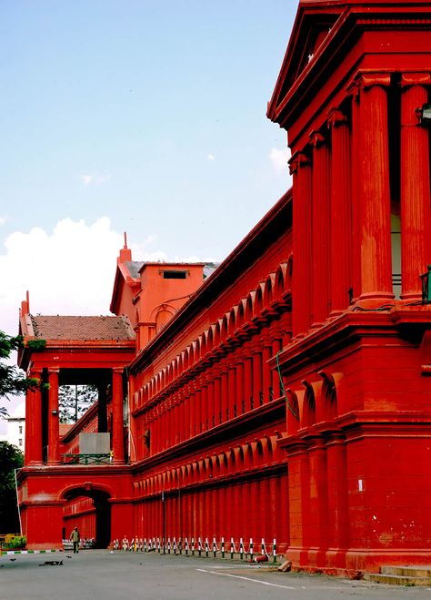 This two-storied building, built in 1867 under the reign of Tipu Sultan, is painted in red with Corinthian columns in Gothic style architecture. It's located at the entrance to Cubbon Park, and houses the High Court and many lower courts. Bangalore City, Amazing India, Central Library, Bangalore India, High Court, Tourist Places, South India, Incredible India, India Travel