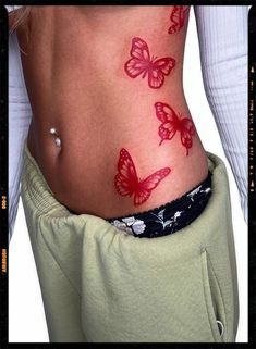 Tattoo Ideas Red Butterfly, Red Butterfly Tattoo Stomach, Red Butterfly Hip Tattoo, Red Butterfly Spine Tattoo, Red Butterfly Back Tattoo, Red Ink Thigh Tattoos Women, Y2k Style Tattoo, Red Rib Tattoos For Women, Butterfly Tattoo On Hip For Women