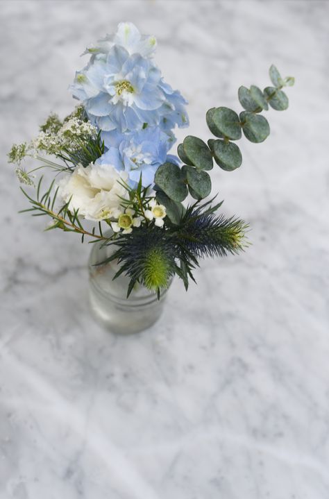 Mini bud vase arrangement, featuring with white, blue blooms and eucalyptus greenery for Jacqueline and  Sylvian Wedding at Brooklyn Winery in Williamsburg. Blue Flower Birthday Party, Blue Flower Arrangements Table, White And Blue Flower Arrangements Simple Centerpieces, Blue And White Bud Vase Centerpiece, Light Blue Flower Centerpieces, Blue And Green Flower Arrangements, Blue Bud Vases Wedding, Dusty Blue Bud Vases, Baby Boy Flower Arrangements