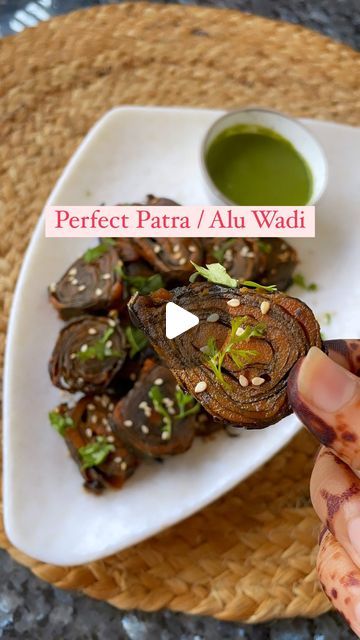 Dhruvi Jain on Instagram: "✨This easy Gujarati Patra recipe gets ready to serve in just under an hour and makes for the perfect snack! 

— Ingredients:
Patra ke leaves / Arbi leaves 
1 1/2 cup gram flour (besan)
1/4 cup wheat flour 
1/4 cup rice flour 
1/2 teaspoon ginger powder
1/2 teaspoon pureed green chillies
salt as required
1 teaspoon powdered turmeric
1/2 teaspoon asafoetida
1/2 teaspoon cumin seeds
1/2 teaspoon garam masala
1/2 teaspoon red chilli powder
1/2 cup tamarind paste + water
1/4 cup jaggery
1/2 teaspoon sesame seeds
water as required

Wash And Remove Veins Of The Leaves.
Dry it completely before applying the Besan mixture.
Grease the steam and gently keep the roll, make sure the roll is tight.
Steam for 40-45 mins & cool completely before cutting.
You can deep fry, shallo Patra Recipe, Ginger Powder, Red Chilli Powder, Tamarind Paste, Deep Fry, Cumin Seeds, Gram Flour, Red Chilli, Chilli Powder