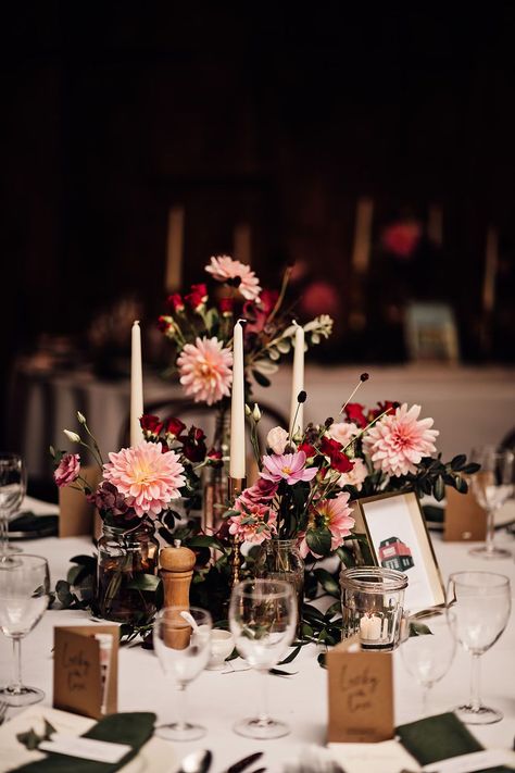 Bud vases full of pink and red wedding flowers and white taper candles for the centrepieces Burgundy Bud Vase Centerpiece, Bud Vase And Candle Centerpiece Wedding Round Table, Dark Rustic Wedding Decor, White Round Table Wedding, Pink Rustic Wedding Decor, Wedding Round Table Flowers, Candle And Bud Vase Centerpiece, Bud Vase Centerpiece Round Table, Pink And Red Wedding Flowers