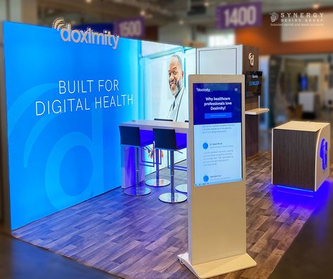 Client Doximity added a kiosk and backlit back wall to their 10x20 exhibit booth for the VIVE show in Nashville, TN. Along with their custom counter with LED lights and 3d Letters. #Doximity #VIVE2023 #HealthcareTechnology #Nashville #Networking #Innovation #VIVE #Tradeshowexhibit #convention #confrence #kiosk #ledcounter #3dletters #10x20exhibit #tradeshow #ledbackwall #customexhibit 10 X 10 Booth Layout, Tech Exhibition Design, Creative Booth Design Exhibition Stands, Convention Booth Design, Tech Booth, Tradeshow Booth Design, Exhibit Design Inspiration, Booth Design Exhibition, Business Exhibition