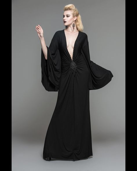 𝕿𝖍𝖊 𝕭𝖊𝖑𝖑𝖆𝖉𝖔𝖓𝖓𝖆 𝕯𝖗𝖊𝖘𝖘 🕸️🩶🕸️ A stunning statement dress with dark Elvira vibes and a dramatic plunging neckline incorporating an ornate roaring twenties-style embellishment. 🦇 Large bat-wing sleeves draped glamorously over your arms make this sensual Vampirish dress an outfit to die for! 🥀 ☞ Tap the Pic to Shop! ⚓ We Ship Worldwide. 🕸 www.gothmall.com 💀 @gothmall 🦇 🕸 🦇 #goth #gothgoth #gothic #gothgirl #gothicgirl #gothfashion #gothicfashion #gothstyle #gothicstyle #gothpeople #darkgirl #inst... Twenties Style, Black Frog, Alternative Dress, Punk Dress, Bat Sleeve, Statement Dress, Gothic Dress, Womens Dress, Leather Outfit