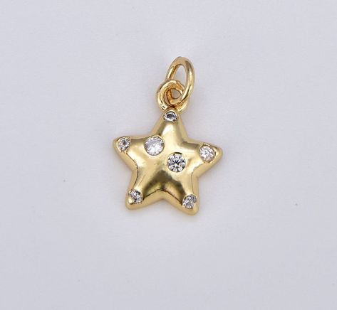 Twinkle Star Gold Charm, Bubble Charm, Bubble Pendant, Bubble Star Charm, Tiny Star Charm  Item specs as below Material: Brass,  Gold Filled Measurement: 16x11mm Quantity: 1 Piece **Please avoid chemical solutions, perfumes, excessive sweat, ocean water and swimming water. Salt water and chlorine can damage your jewelry. Chlorine can damage and discolor metals that are alloyed with the gold and can slowly erode the finish and polish of gemstones. Also, lotions and sprays create a film on the jewelry, making it dull and dingy. To keep any tarnish or wear from setting in, take a soft, damp cleaning cloth and gently wipe off the surfaces of the jewelry, being sure to get in all the nooks and crannies. Keep jewelry dry. Moisture is the main factor that speeds up the tarnishing process. Store d Twinkle Star, Tiny Star, Necklace Pendants, Jewelry Charms, Ocean Water, Layered Jewelry, Necklace Charm, Jewelry Outfit, Brass Gold