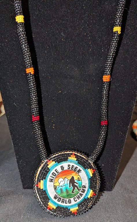 Beaded Bigfoot medallion. Planar Center. Black, blue, red, yellow , and orange Czech seed beads. Buckskin backing. Beaded Bigfoot, Bead Bracelet Patterns, Seed Bead Bracelet Patterns, Seed Bead Bracelet, Beaded Bracelet Patterns, Seed Bead Bracelets, Beaded Pendant, Bracelet Patterns, Bead Bracelet