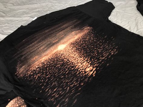 Sunset reflected on water painted on a black t-shirt using bleach. If you're unsure what size to choose I recommend picking a larger one as fruit of the loom T-shirt's are on the smaller side. Hand Painted Bleach Shirt, Black Bleached Shirt, Bleaching Clothes, Bleach T Shirts, Bleach Dye, Beach Design, Fruit Of The Loom, Water Painting, Black Fabric