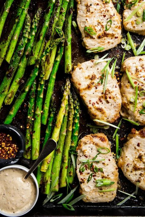 One pan. 30 minutes. Irresistibly delicious and healthy, this tender baked pork chop and asparagus sheet pan dinner gets a major flavor boost from a simple, genius garlicky mayo-mustard sauce. Modern Proper Sheet Pan, Pork Asparagus Recipes, Sheet Pan Pork Chops And Asparagus, Pork Chop Asparagus Recipes, Pork Chops With Asparagus, Pork Chops And Asparagus In Oven, Pork Chop And Asparagus Recipes, Pork And Asparagus Recipes, Pork Chops And Asparagus