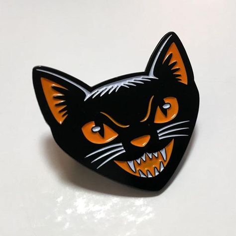 The Black Cat head enamel pin features a vintage-style Halloween feline in a limited Samhain palette of orange, black and white. 1.4"W x 1.4" H Also available: the Black Cat head embroidered patch, the "Black Magic" Halloween motorcycle club patch, and the Black Cat t-shirt �— all featuring this black cat artwork. Halloween Motorcycle, Black Cat Artwork, Cat Beanie, Cat Enamel Pin, Cat Reference, The Black Cat, Motorcycle Club, Toy Design, Pinterest Ideas