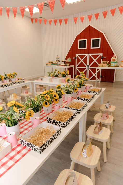 This birthday party exuded the farm theme to a tee. The blank raw space had a large red farm barn door installation, yellow sunflowers that lined each petite table and sweet treats in the shape of animals. The intricate details provided by Evoke Design and Creative made this party sensational, right down to the hay bale decor. Farm Baby Birthday, Hay Bale Decor, Barn Birthday Party, Farm Party Decorations, Animal Themed Birthday Party, Farm Themed Party, Barnyard Birthday Party, Barn Door Installation, Farm Theme Birthday