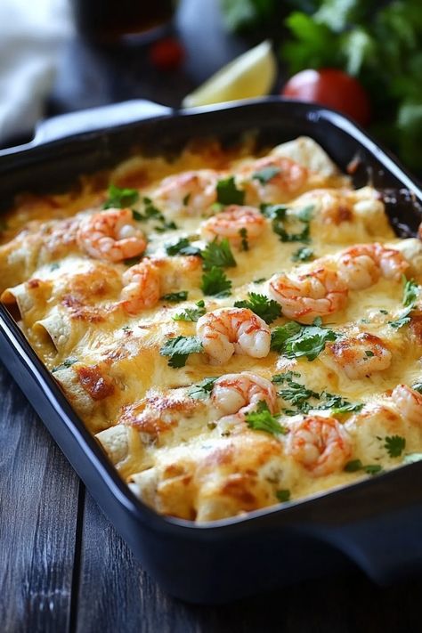 Baked shrimp enchiladas topped with melted cheese and cilantro in a black baking dish. Shrimp Taquitos, Recipes With Cooked Shrimp, Shrimp Make Ahead Meal, Shrimp And Crab Enchiladas, Dinner Ideas With Shrimp, Easy Shrimp Enchiladas Recipes, Shrimp Quesadilla Recipes, Enchiladas Shrimp, Creamy Shrimp Enchiladas Recipe