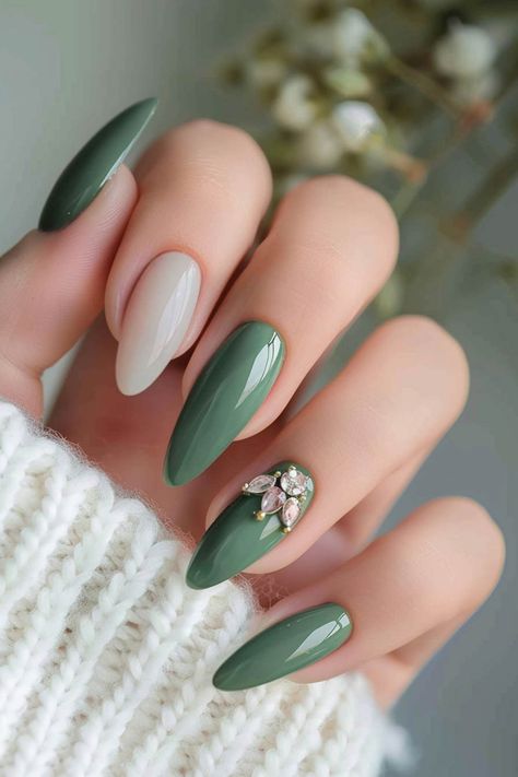 Close-up of a hand with stylish almond-shaped nails, featuring a glossy green and cream color scheme and an accent nail with floral nail art. Nice Green Nails, Sage Green Manicure, Dark Sage Green Nails, Nail Colora, Trendy Green Nails, Sage Green Nail Ideas, Manicure Elegante, Pink Valentines Day Nails, Sage Green Nail