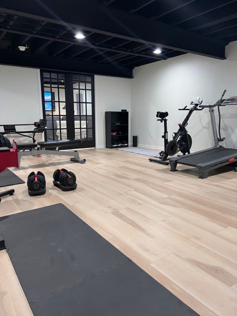 Basement Gym And Family Room Floor, Basement Gym Black Ceiling, Basement Remodel Black Ceiling, Home Gym Black Ceiling, Black And White Home Gym, Basement Gym Remodel, Basement Gym Lighting, Unfinished Basement Workout Room, Basement With Black Ceiling