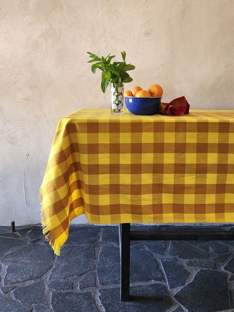 Plaid and striped tablecloth in yellow and ochre. White zig zag detail down the center of the tablecloth. For use as a tablecloth, but also works well as a beach throw. 64” x 90” This textile is handwoven, and we embrace imperfections and irregularities in the weave, as they are evidence of the human hand. We hope you do too. 100% cotton. Machine wash and dry normal with like colors. Handwoven in Chiapas, Mexico. Eclectic Kitchen Decor, Striped Tablecloth, Yellow Tablecloth, Gingham Tablecloth, Embrace Imperfections, Eclectic Kitchen, Beach Throw, Human Hand, Boho Designs