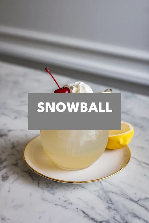 A photo of a  Snowball a winter cocktails Highland Snowball Drink, Snowball Drink Recipe, Snow Themed Cocktails, Fun Winter Cocktails, Snowball Cocktail, Snowball Drink, Snowball Cocktail Recipe, Warm Winter Cocktails, Boozy Recipes