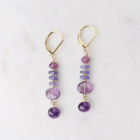 Riverstone Jewelry designer Jill Scholsohn creates vibrant jewelry using a mixture of amulets & talismans along with rare, exotic beads and mediums from sourced from several cultures spanning the globe. Ruby, tanzanite, amethyst oval, amethyst onion 2" drop All natural stones slight variations in color will occur Gold filled lever back ear wires Handmade in CT Gemstone Earring Ideas, Vibrant Jewelry, Wired Jewelry, Handmade Crystal Jewelry, Earrings Ideas, Girls Heart, Tanzanite Jewelry, Natural Stone Earrings, Wire Jewelry Designs