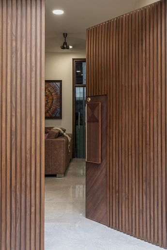 Refurbishing To The Breezy And Earthy Interiors | SPDA - The Architects Diary Pintu Interior, Bungalow Interiors, House Main Door, Modern Entrance Door, Unique Interiors, Modern Exterior Doors, House Main Door Design, Main Entrance Door Design, Wooden Front Door Design