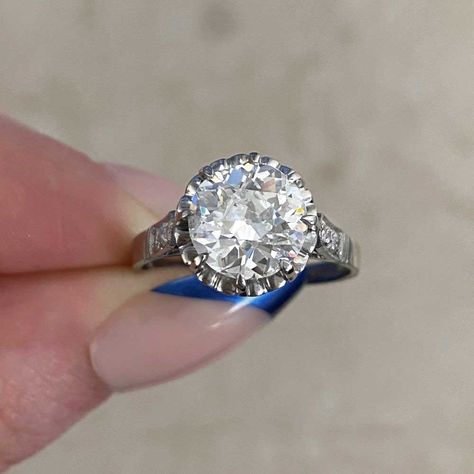 This elegant antique ring features an old European cut diamond center that is set in prongs and GIA-certified as 2.32 carats, J color, and SI2 clarity. Flanking each shoulder are three additional old European cut diamonds. This ring is further enhanced with a heart-style openwork design in the under-gallery, with two rows of additional old European cut diamonds set underneath and fine milgrain. The total approximate weight of the additional diamonds is 0.28 carats. From the Art Deco era, circa 1 Vintage Diamond Earrings, European Cut Diamond Ring, Estate Diamond Jewelry, Designer Diamond Jewellery, Colored Diamond Rings, Flash Mob, Cushion Cut Ring, Fancy Diamonds, Antique Engagement Rings