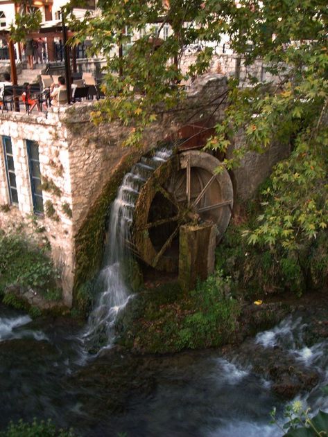 The Greek city with watermills, waterfalls, stone bridges and age-old plane trees | GHD Greek Countryside, Stone Bridges, Windmill Water, Santorini Villas, Water Wheels, Old Bridges, Greek City, Wind Mills, Old Planes