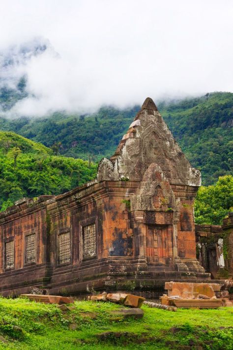 This is a 12th-century Hindu temple with a similar architecture as Angkor of Cambodia. Set against the breathtaking natural backdrop, Vat Phou is in Champasak, a UNESCO World Heritage Site in southern Laos. This temple currently serves as a Buddhist site. Laos offers incredible serenity with the beautiful Buddhist sites, untamed natural beauty and also the fact that it is so cheap you would love to visit again. Here are our top five things to do in Laos. Champasak, Types Of Architecture, Ancient Greek Architecture, Asian Architecture, Landlocked Country, Vientiane, Luang Prabang, Summer Destinations, Hindu Temple