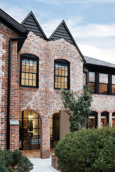 red brick and black trim Tudor home Black Trim On Brick House, Red Brick And Black House, Red Brick Exterior With Black Windows, Black Trim Red Brick House, Black Trim Exterior House Brick Homes, Red Brick House With Black Windows, Red And Black Brick House Exterior, Front Doors On Brick Houses, Brick Home Black Trim