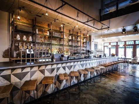 The long bar counter is clad in black and white geometric pattered tiles, paired with bar stools made from tubular black steel and wooden planks.  John Salt Bar in London Bar In Casa, Bar Design Awards, Bar Inspiration, London Bars, Bar Interior, Bar Design Restaurant, Tap Room, Restaurant Interior Design, Hospitality Design