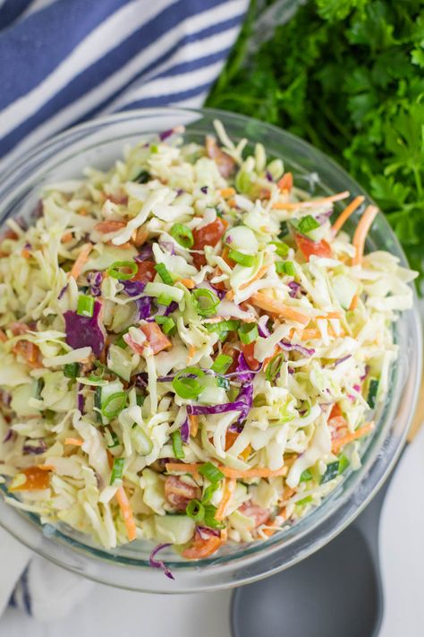 This Summer Slaw takes our family favorite southern coleslaw recipe and adds fresh summer vegetables, including cherry tomatoes, cucumbers, and green onions, and tosses it in a creamy, tangy dressing. Easy to make and a perfect summer side! Summer Slaw Recipe, Southern Coleslaw Recipe, Pea Salads, Grill Sides, Southern Coleslaw, Summer Slaw, Cabbage Slaw Recipes, Pea Salad Recipes, Southern Potato Salad