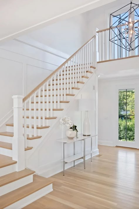 Stunning light wood staircase with wood and white railings. Custom wall paneling. Black chandelier. Light wood floors. Slim frame windows. Staircase Design White And Wood, Double Landing Staircase, Light Wood Banister, Cottage Core Staircase, All White Stair Railing, White Wood Staircase, White Stair Railing Ideas, White Wood Stairs, Stairs Banister Ideas