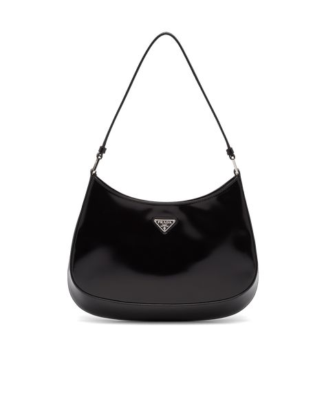 The Prada Cleo bag with sophisticated allure reinterprets an iconic design of the brand from the 1990's. Sleek curved lines emphasized by the particular construction rounded on the bottom and sides give this hobo bag a soft, light look. Brushed leather, a modern and versatile material that is distinctive in Prada collections, is ideal for creating always new combinations and contrasts. The enamel triangle logo decorates the silhouette. Prada Cleo Bag, Tas Prada, Cleo Bag, Tas Vintage, Prada Cleo, Tas Mini, Prada Collection, Bag Prada, Hardware Logo