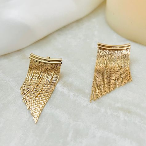 Dazzle in this glamorous pair of gold fringe earrings! This short tassel statement piece is designed with a beautiful gold fringe that creates a cascade of sparkle and shine anywhere you move. They are perfect for any cocktail party, wedding, or social gathering, making it a must piece in your jewelry collection!  ⭐️About Our Earrings:  Our earring collection ranges in styles to choose from. It contains the perfect earrings to complement and highlight the beautiful features of your face. Whether Gold Hanging Earrings, Simple Studs, Cocktail Party Wedding, Beautiful Features, Jacket Earrings, Pulled Back Hairstyles, Gold Fringe, Ear Jacket Earring, Angel Hair