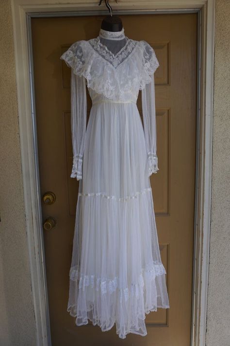 Beautiful Gunne Sax white layered dress. In good condition but is missing two buttons from at back of neck - see last photo. Labeled as a size 7 but fits like modern size 5.Measurements taken across front laid flat17" across front armpit to armpit13" across front of waist58" length 1970s Prairie Dress, 70s White Dress, Gunne Sax Wedding Dress Vintage 70s, Vintage White Dresses, 1970 Wedding Dress, White Gown, 70s Wedding Dress Vintage, Vintage White Dress, White Lace Dress