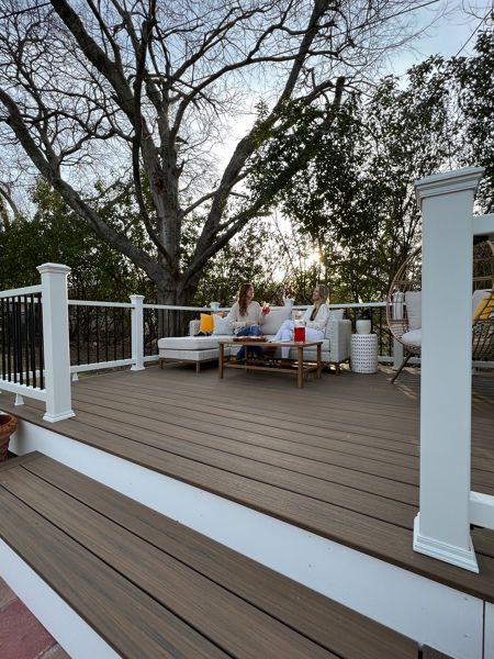 "My family and I enjoy spending our weekend evenings on the deck. It’s a great space to take in the sunset, listen to music, and relax after a long week. It gives us a dedicated space for our cherished family time," shares Trex homeowner, Ashley. Scroll to see the charming outdoor space she built with her friend, Charlee of Build & Create Home, using the Trex “Deck in a Box” Kit. Picture Frame Deck Design, Front Deck Ideas, Trex Deck Ideas, Trex Patio, Small Deck Designs, Trex Deck Colors, Trex Colors, Gray Deck, Trek Deck