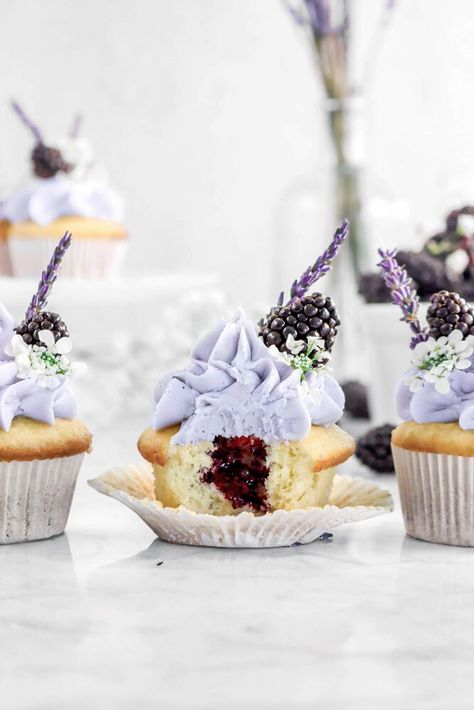 Welcoming in the Springtime with these delicious Vanilla Cupcakes with Blackberry Jam Filling and the sweetest Lavender Frosting! Every bite of is like a warm embrace of the sun...with sweet floral notes. Made with simple ingredients, the vanilla cupcakes are light, fluffy, and everything a perfect cupcake should be. Lightly sweet, hints of vanilla, and so simple to make...but the real stars of the show are the homemade blackberry jam and the super simple lavender frosting! The jam is… Blackberry Lavender Jam, Lavender Frosting, Blackberry Cupcakes, Homemade Blackberry Jam, Lavender Jam, Lavender Cupcakes, Purple Food Coloring, Cupcake Decorating Tips, Culinary Lavender