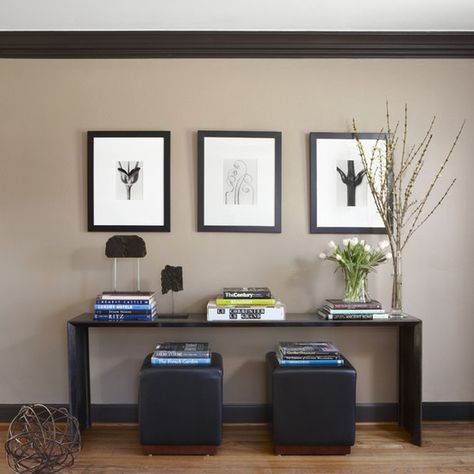 Cute idea - I would use this as an entryway table for mail and maybe put hooks on the way for keys. I'd love to find ottomans that fit under that people could move over for extra seating. "Dark Trim Design, Pictures, Remodel, Decor and Ideas" Dark Wood Trim, Tan Walls, Taupe Walls, Dark Trim, Brown Rooms, Eclectic Living Room, Brown Walls, White Ceiling, Living Room Remodel