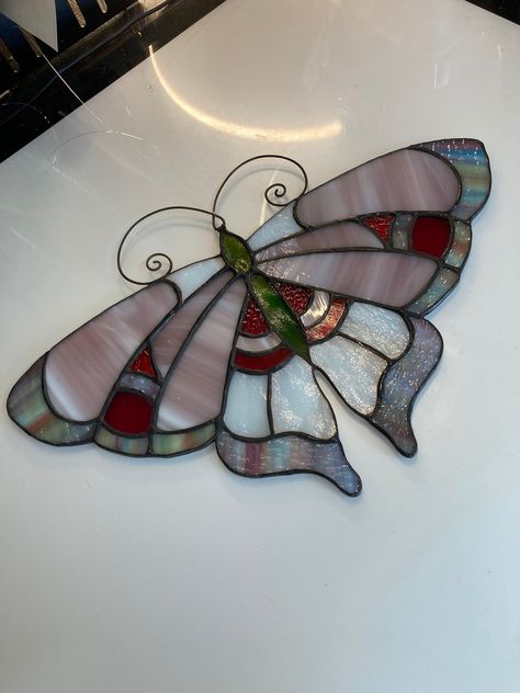 "stained glass window hanging Butterfly moth Art Deco In Pink and red Usa Handcrafted. This handcrafted butterfly moth suncatcher was created using pink milky glass, red textured and red iridescent glass, multicolored art glass, white opal glass, and green glass with silver iridescent coating for its body, wire work antenna made of brass with line attached for hanging. Finished off with an antique patina for a lovely contrast. polished to a high gloss finish. measures aprox. 8\" inches tall x 11.5\" inches wide USPS shipping fully insured  I take great pride in all my works, everything is handcrafted with only top quality materials for a beautiful work of art that with proper care can last a lifetime. not mass produced, this is unique in that no two works are exactly alike." Hanging Butterfly, Diy Stained Glass Window, Stained Glass Candles, Stained Glass Patterns Free, Moth Art, Fused Glass Artwork, Stained Glass Birds, Stained Glass Butterfly, Stained Glass Decor