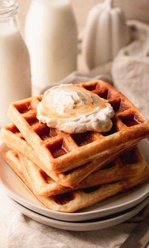 Belgian waffles stacked on a plate and topped with whipped cream and maple syrup. Maple Waffles Recipe, Waffles With Whipped Cream, Pumpkin Cinnamon Waffles, Pumpkin Waffles With Apple Cider Syrup, Fall Waffles, Pumpkin Spice Belgian Waffles, Honey Garlic Ribs, Parmesan Crusted Zucchini, Pumpkin Spice Waffles