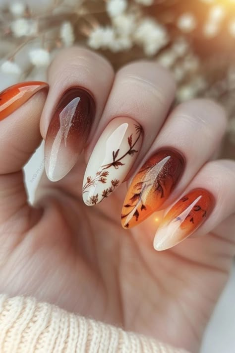 Autumn-themed manicure with gradient shades and leaf designs. Nails Fade Color, October Birthday Nail Ideas, Pink And Brown Ombre Nails, Ombre Fall Nail Colors, Water Colour Nail Design, Autumn Almond Nails Design, Maroon And Orange Nails, Thanksgiving Ombre Nails, Ombre Autumn Nails