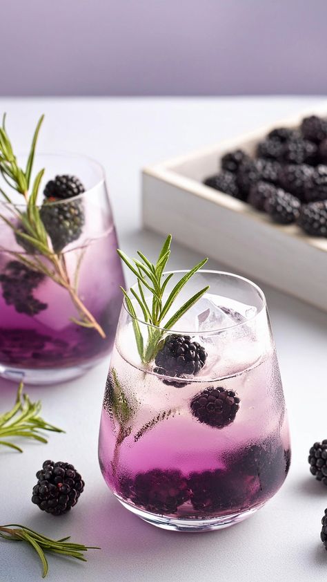 Delight your senses with the vibrant Rosemary Blackberry Bramble, a gin cocktail that combines the sweetness of blackberries with the aromatic notes of rosemary syrup. This refreshing drink is perfect for a summer evening or any special occasion. Blackberry Gin Recipe, Blackberry Sage Cocktail, Gin Rosemary Cocktail, Bramble Gin Cocktail, Blackberry Drink, Blackberry Rosemary Cocktail, Blackberry Gin Cocktail, Witch Cafe, Blackberry Gin And Tonic