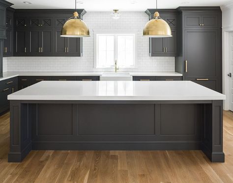 Black Kitchen Cabinets with White Quartz Countertop, White Oak Hardwood Floor, Brass accents and white subway tile with dark grout. Dark inset cabinets bring a modern feel to this classic kitchen. The overall size of the kitchen is 21’6” wide by 13’6” deep. The kitchen island is roughly 11’ wide by 4’6” deep. Kitchen lighting is Eugene Large Pendant - Hand-Rubbed Antique Brass from Circa Lighting. Black Kitchen Cabinets with White Quartz Countertop, White Oak Hardwood Floor, Brass accents and... Kitchen Cabinet Inspiration, Серая Кухня, Dark Grey Kitchen, Best Kitchen Cabinets, Farmhouse Kitchen Cabinets, Black Kitchen Cabinets, New Kitchen Cabinets, Kitchen Cabinets Makeover, Grey Kitchen Cabinets