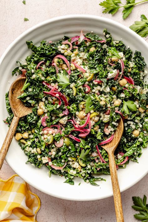 Fresh, herby kale couscous salad with feta, chickpeas, and olives that comes together in just 30 minutes for a satisfying lunch or side dish. Scoop up this beautiful salad with tortilla chips or pitas chips to get an extra delicious crunch! You'll love this veggie-packed salad as is or with your favorite grilled proteins. Ambitious Kitchen Kale Couscous Salad, Antiinflammatory Salad Recipes, Trendy Salads, Salad Ideas Aesthetic, Couscous Salad Recipes Cold, Prepped Salads, Nutrient Dense Lunch, Kale Couscous, Dinner Salad Recipes