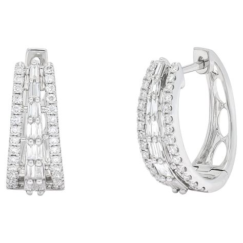 Elevate your style with sophistication and grace wearing these exquisite hoop earrings, adorned with brilliant baguette and shimmering round-cut diamonds set in gleaming 18 KT White Gold. Totaling 0.74 carats, the diamonds in these designer hoops are meticulously arranged to catch the light from every angle, creating a dazzling display of elegance. The combination of baguette and round-cut diamonds adds a unique texture and sparkle to these earrings, making them a standout accessory for any special occasion. Whether given as a thoughtful gift or worn to complement a special outfit, these hoop earrings are a symbol of refined luxury and timeless style. Their versatile design ensures they can be effortlessly paired with both formal and casual ensembles, adding a touch of glamour to any look. Belgian Modern, Diamond Accessories, White Gold Hoops, Earrings Making, Color Dorado, Memorable Moments, Gold Hoop, Elegant Gift, Round Cut Diamond