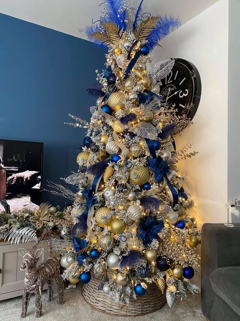 Blue silver and gold Flocked Christmas Trees Decorated Blue And Gold, White Blue And Gold Christmas Tree, Christmas Tree Blue Silver And Gold, Christmas Tree Royal Blue, Blue Gold And White Christmas Decor, Blue Decoration Christmas Tree, Silver Gold And Blue Christmas Tree Decor, Royal Blue Gold Christmas Tree, Christmas Tree Ideas Navy Blue And Gold