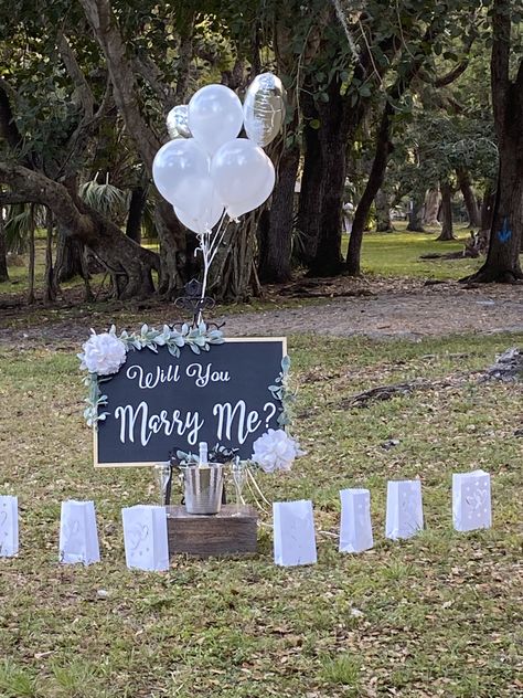 Wood chalkboard board decorated with green leaves and white wedding flower bouquet, white vinyl and message: Will you marry me?  Size: 35”wide x 25” tall  Special request $100 Production 3-5 business days. Will You Marry Me Poster Board Ideas, Will You Marry Me Aesthetic, Proposal Setup Ideas, Romantic Dates Ideas, Creative Proposal Ideas, Board Painting Ideas, Proposal Setup, Marry Me Sign, White Wedding Flowers Bouquet