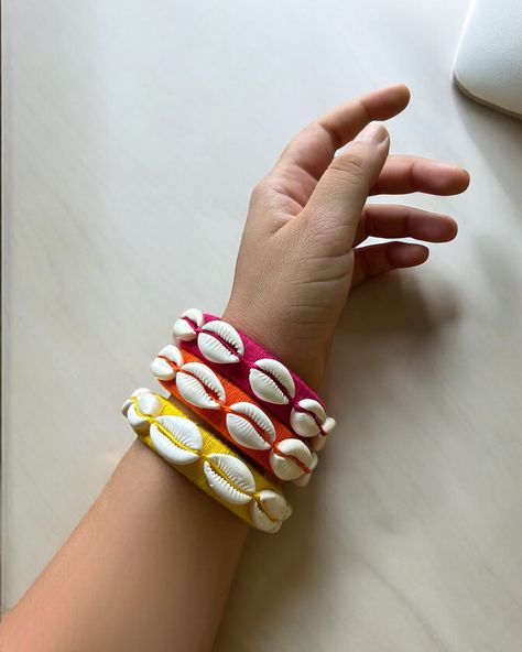 Shell-abrate in style! Introducing our vibrant, HANDMADE bangle set featuring stunning cowrie shells.Perfect for adding a pop of color to your outfit and making a statement! Each bangle is carefully handcrafted with love and attention to detail, ensuring that every cowrie shell is perfectly placed. The result is a truly unique and eye-catching piece of jewelry that's sure to turn heads! Whether you're heading to the beach, a festival, or just running errands, these bangles are the perfect a... Cowrie Shells, Handmade Bangles, Cowrie Shell, Bangle Set, Running Errands, With Love, Color Pop, The Beach, Shells