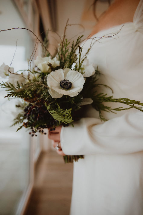 The perfect winter bouquet. See all the enchating details from this suprise holiday wedding up on the blog now. Simple Greenery Bouquet, Winter Wedding Small Simple, Evergreen Bouquet Wedding, White Poppy Wedding Bouquet, Scandinavian Winter Wedding, December Flowers In Season, Small Wedding Bouquets Winter, January Wedding Bouquet, Timeless Winter Wedding