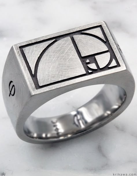 This signet ring is perfect for those who appreciate mathematics. A spiral representing the Fibonacci Golden Ratio is etched into the flat surface on top of the ring. The sides have numbers and a Greek letter. Combining intricate designs, the highest quality of craft and materials, and heady designs inspired by mobius strips, geometries, and mathematical and scientific concepts, this collection will invigorate your left and right brain. Men's Jewelry Rings Silver, Men’s Ring Design, Men’s Ring, Mechanical Ring, Geek Wedding Rings, Fashion For Men Over 40, Left And Right Brain, Masculine Wedding, Architectural Rings