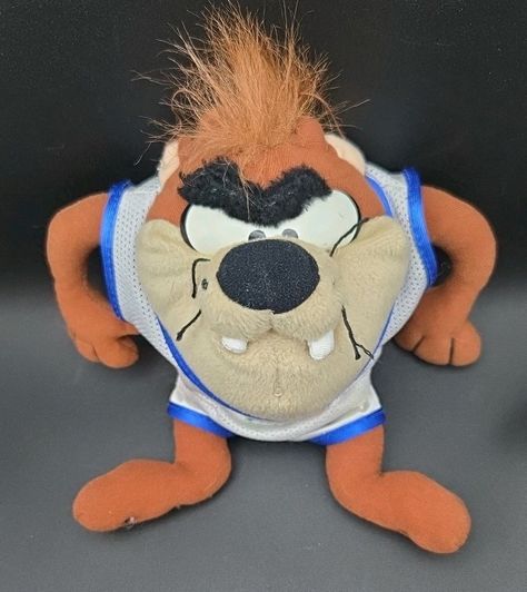 A 1996 Tasmanian Taz 8" Space Jam McDonald's plush featuring the Looney Tunes character Taz from Warner Bros. This stuffed animal is part of a McDonald's promotion related to the movie "Space Jam" and the Looney Tunes character family. Looney Tunes Characters, Space Jam, Looney Tunes, Warner Bros, Stuffed Animal, Jam, Promotion, Animals