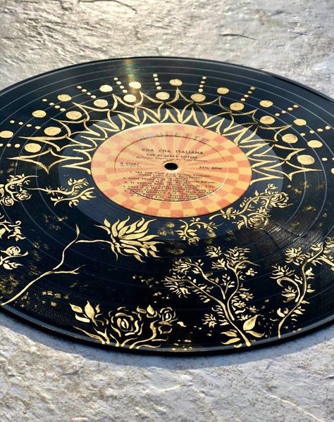 "12\" 33 RPM painted vinyl record All gold acrylic florals are contrasted with a gold mandala-like geometric print.  I get ideas for my paintings spending time walking through arboretums and hiking the rural landscapes of Kentucky. Take an original piece home with you to experience the floral wonders of my backyard." Decorated Vinyl, Vynal Painting Ideas, Records Painted, Cds Art, Art With Vinyl Records, Cute Painted Records, Vinyl Records On Wall, Painted Vinyl Records Aesthetic, Vinyl Painting