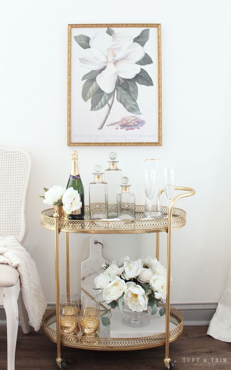 Bar Cart Styling Tips and Ideas with Tuft & Trim Interior Design Bar Cart Sitting Area, Neutral Bar Cart Styling, Sophisticated Bar Cart, Gold Bar Cart Decor, Bar Cart Apartment Small Spaces, Serving Cart Decor Ideas, Gold Bar Cart Decor Ideas, Trolley Cart Ideas, Bar Trolley Styling